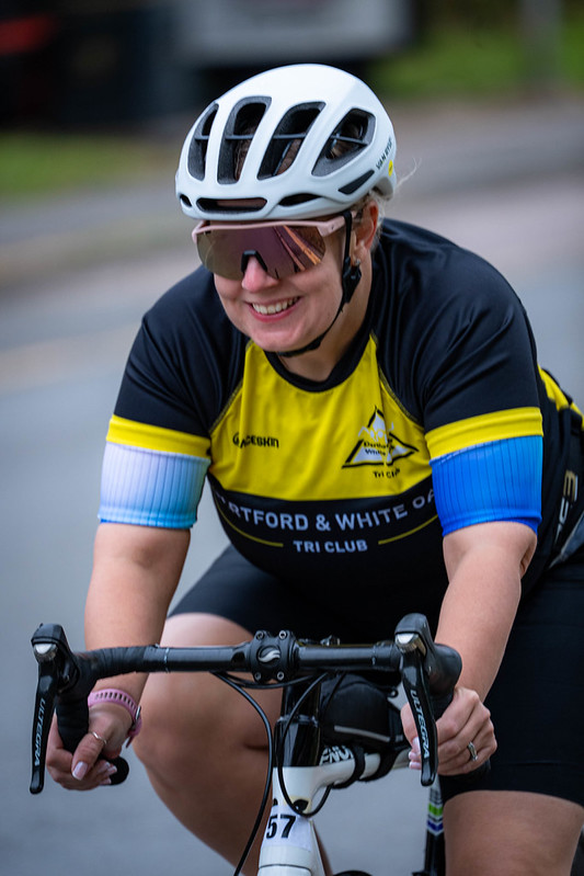 Club cyclist smiling mid-ride