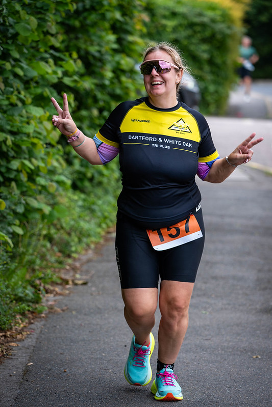 Club member giving peace signs mid-race